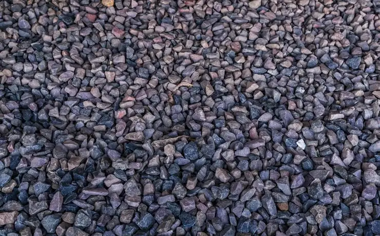 Crushed granite up close, the kind of stone a base for parking or a road is built from